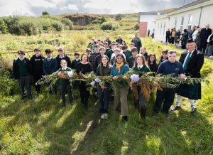 Students and staff holding a wreath.