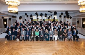 Apprentices throwing caps in the air